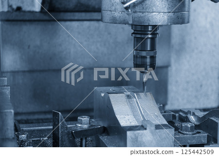 The CNC milling machine cutting  mold part by solid ball nose end mill tool in the light blue scene. 125442509