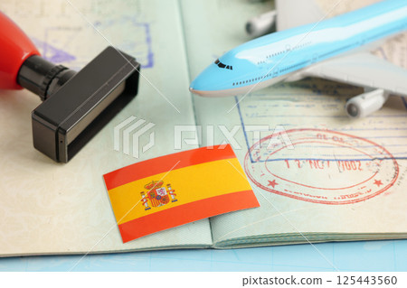 Spain passport with approved stamp on document for tourism. 125443560