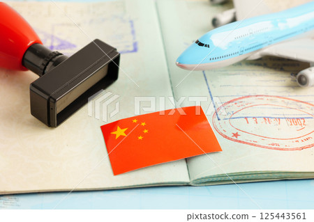 China passport with approved stamp on document for tourism. China passport with approved stamp on document for tourism. 125443561