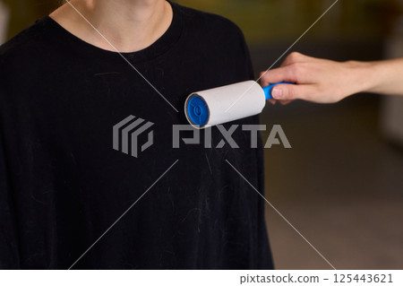 Proper and effective use of a lint roller is essential for keeping your fabrics clean and fresh Proper and effective use of a lint roller is essential for keeping your fabrics clean and fresh 125443621