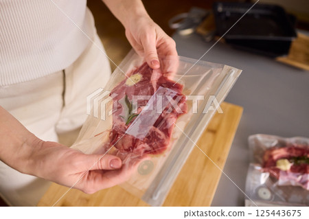 Sealing Fresh Meat for Preservation Using a Vacuum Sealer for Longer Lasting Freshness 125443675