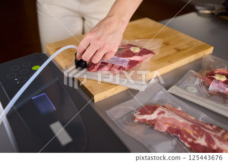 Sealing Fresh Meat for Preservation Using a Vacuum Sealer for Longer Lasting Freshness Sealing Fresh Meat for Preservation Using a Vacuum Sealer for Longer Lasting Freshness 125443676