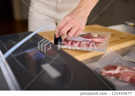 Sealing Fresh Meat for Preservation Using a Vacuum Sealer for Longer Lasting Freshness 125443677
