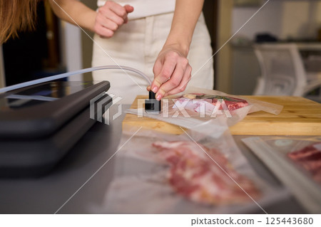 Sealing Fresh Meat for Preservation Using a Vacuum Sealer for Longer Lasting Freshness Sealing Fresh Meat for Preservation Using a Vacuum Sealer for Longer Lasting Freshness 125443680