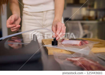 Sealing Fresh Meat for Preservation Using a Vacuum Sealer for Longer Lasting Freshness Sealing Fresh Meat for Preservation Using a Vacuum Sealer for Longer Lasting Freshness 125443681