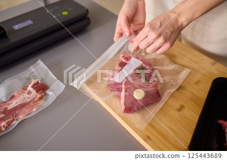 Sealing Fresh Meat for Preservation Using a Vacuum Sealer for Longer Lasting Freshness Sealing Fresh Meat for Preservation Using a Vacuum Sealer for Longer Lasting Freshness 125443689