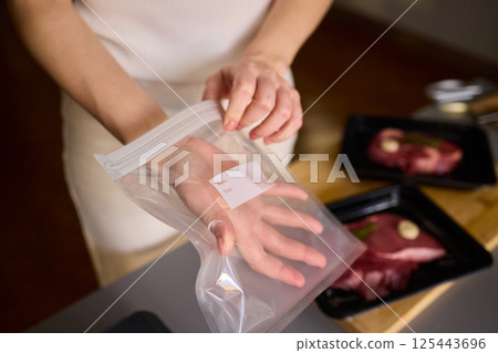 Sealing Fresh Meat for Preservation Using a Vacuum Sealer for Longer Lasting Freshness 125443696