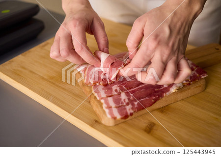 Artisan Style Meat Preparation on a Beautifully Crafted Wooden Board for Serving Artisan Style Meat Preparation on a Beautifully Crafted Wooden Board for Serving 125443945