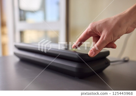 A person interacting with a touchscreen device to enhance their overall engagement and experience 125443968