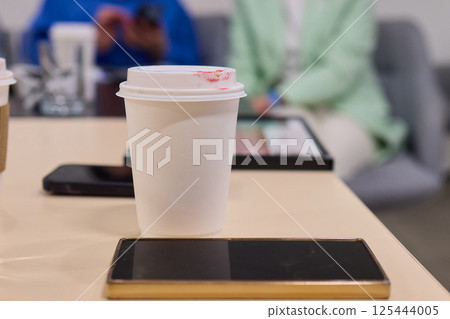 A Casual Coffee Meeting that Incorporates Digital Devices for Enhanced Productivity and Enjoyment A Casual Coffee Meeting that Incorporates Digital Devices for Enhanced Productivity and Enjoyment 125444005