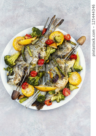 Grilled fish with vegetables. Grilled fish with vegetables. 125444346