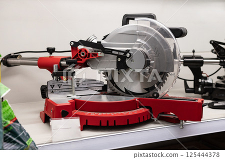 Precision miter saw displayed in a workshop setting showcasing detailed craftsmanship and versatility in woodworking projects 125444378