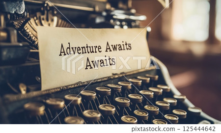 Vintage typewriter with "Adventure Awaits" message. 125444642