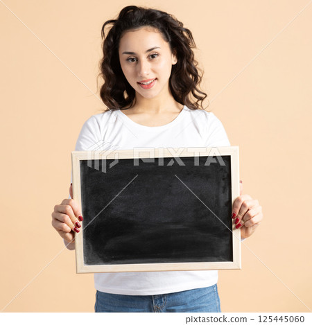 Woman studio portrait with blackboard Woman studio portrait with blackboard 125445060