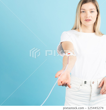 Conceptual image of woman giving blood 125445274