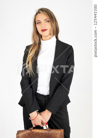 Business woman with black suit and brown suitcase 125445380