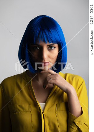 Portrait of beautiful woman in blue wig and yellow t-shirt Portrait of beautiful woman in blue wig and yellow t-shirt 125445561
