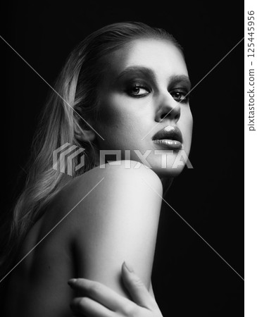Beautiful woman with fancy make-up and naked shoulder studio portrait 125445956