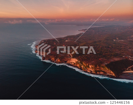 Drone view of Bukit peninsula with cliffs and ocean at sunset in Bali 125446156