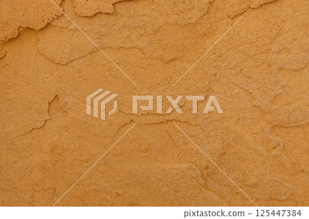 Close up of textured ochre wall surface 125447384