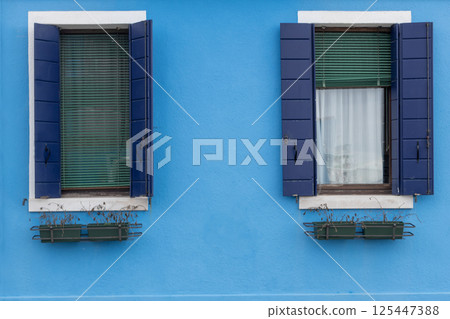 Blue facade with shuttered windows in Burano Blue facade with shuttered windows in Burano 125447388