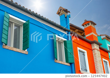 Colorful upper facades with chimneys in Burano 125447402