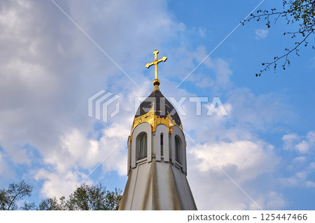 Golden cross on the dome of the church against the sky Golden cross on the dome of the church against the sky 125447466