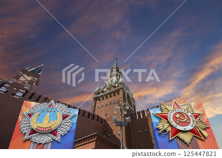 Moscow Kremlin (with orders of victory)--Victory Day celebration (WWII), Russia-- the most popular view. Against the sky with clouds. English translation from Russian: USSR, Victory, Patriotic war 125447821