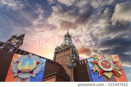 Moscow Kremlin (with orders of victory)--Victory Day celebration (WWII), Russia-- the most popular view. Against the sky with clouds. English translation from Russian: USSR, Victory, Patriotic war 125447822