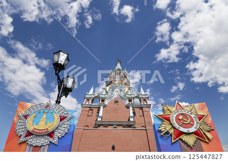 Moscow Kremlin (with orders of victory)--Victory Day celebration (WWII), Russia-- the most popular view. Against the sky with clouds. English translation from Russian: USSR, Victory, Patriotic war 125447827