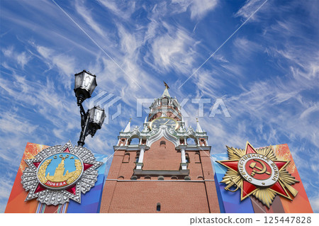 Moscow Kremlin (with orders of victory)--Victory Day celebration (WWII), Russia-- the most popular view. Against the sky with clouds. English translation from Russian: USSR, Victory, Patriotic war 125447828