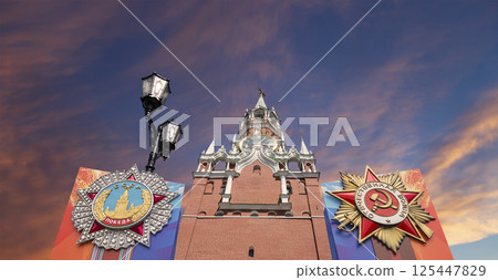 Moscow Kremlin (with orders of victory)--Victory Day celebration (WWII), Russia-- the most popular view. Against the sky with clouds. English translation from Russian: USSR, Victory, Patriotic war 125447829