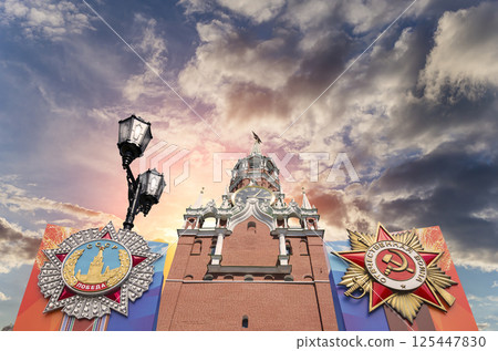 Moscow Kremlin (with orders of victory)--Victory Day celebration (WWII), Russia-- the most popular view. Against the sky with clouds. English translation from Russian: USSR, Victory, Patriotic war 125447830
