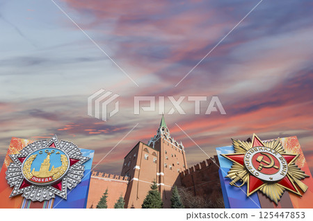 Moscow Kremlin (with orders of victory)--Victory Day celebration (WWII), Russia-- the most popular view. Against the sky with clouds. English translation from Russian: USSR, Victory, Patriotic war 125447853