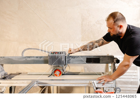 Construction Worker Using Tile Saw Cutting Ceramic Tiles Construction Worker Using Tile Saw Cutting Ceramic Tiles 125448065