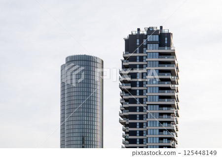 Modern Urban Skyscrapers with Glass Facades and Balconies in a City Landscape Modern Urban Skyscrapers with Glass Facades and Balconies in a City Landscape 125448149
