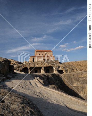 Church of uplistsikhe standing on a hill in a sunny day with blue sky and some clouds Church of uplistsikhe standing on a hill in a sunny day with blue sky and some clouds 125449784