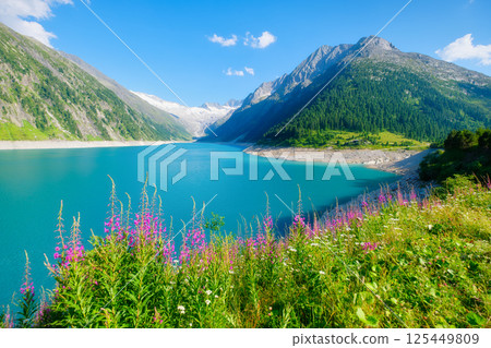 Azure lake and high mountain range in Austria. Mountain landscapes during summer. Azure lake and high mountain range in Austria. Mountain landscapes during summer. 125449809