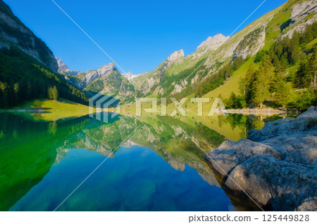 Seealpsee, Switzerland. Lake and reflections on the water surface. Mountain landscapes in summer. 125449828