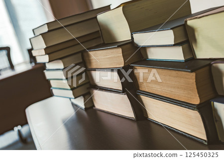 A room with thick technical books 125450325