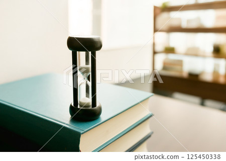 Hourglass and technical book 125450338
