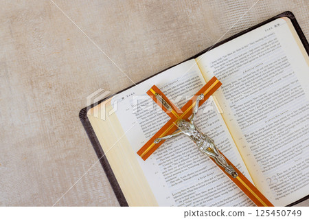 24 April 2025 Washington DC US Crucifix rests on an open Bible, symbolizing faith, spirituality in serene environment. 125450749