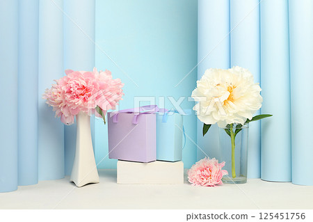 Stage for product display and business concept for shopping promotion. Empty premium podium with gift boxes. Beautiful flower arrangement with peonies, elegant beauty concept Stage for product display and business concept for shopping promotion. Empty premium podium with gift boxes. Beautiful flower arrangement with peonies, elegant beauty concept 125451756