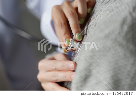 Muslim female doctor using a stethoscope to examine a patient, emphasizing thoroughness and care in healthcare. 125452017