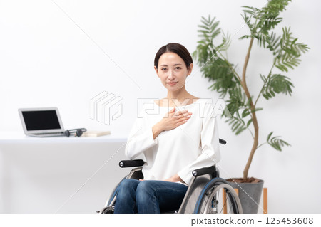 Woman in wheelchair, work from home, leave it to us 125453608