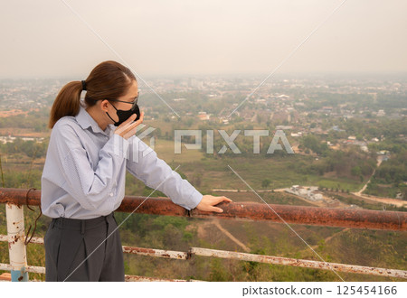 Asian businesswoman coughing becaused of allergy from Bad air pollution (PM2.5). Asian businesswoman coughing becaused of allergy from Bad air pollution (PM2.5). 125454166