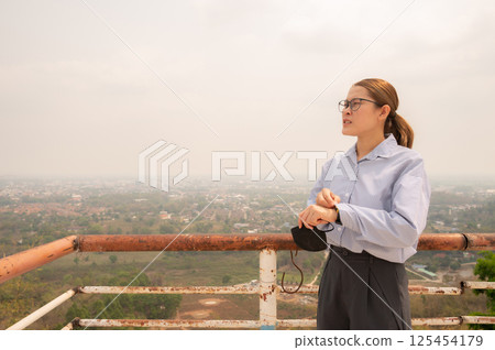Asian businesswoman feel worrying about bad air pollution covered her hometown in Thailand. 125454179