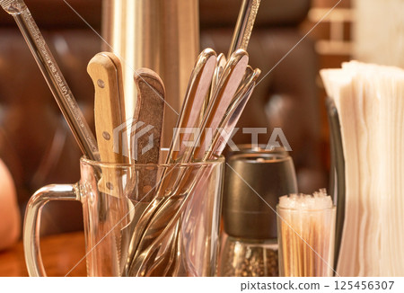 Set of kitchen utensils in a glass jar, closeup. Selective focus. 125456307
