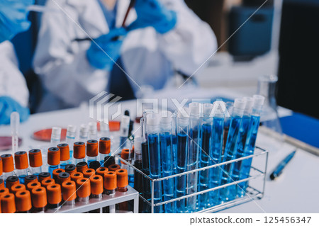 Researcher using a professional microscope 125456347