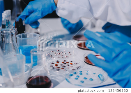 Researcher using a professional microscope 125456360